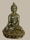 A serene Buddha statue from the Saanskrityam Handicraft Store's Buddha Dharma collection elegantly holds a bowl in its lap. Featuring intricate hair curls, elongated ears, and a flame-like ornament atop its head, this piece enhances any Buddha collection. It stands gracefully on a round, decorated base.