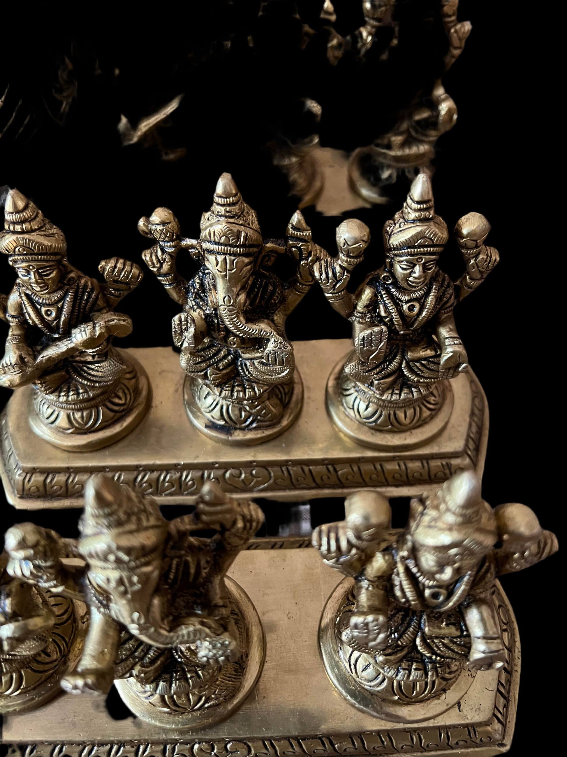 This brass Lakshmi statue from Saanskrityam Handicraft Store features the Goddess MahaLakshmi seated with four arms. She holds lotus flowers in two hands while displaying symbolic gestures with the others. Adorned with intricate jewelry and a serene expression, she embodies wealth and prosperity, making it an ideal choice for festive and auspicious gifts.