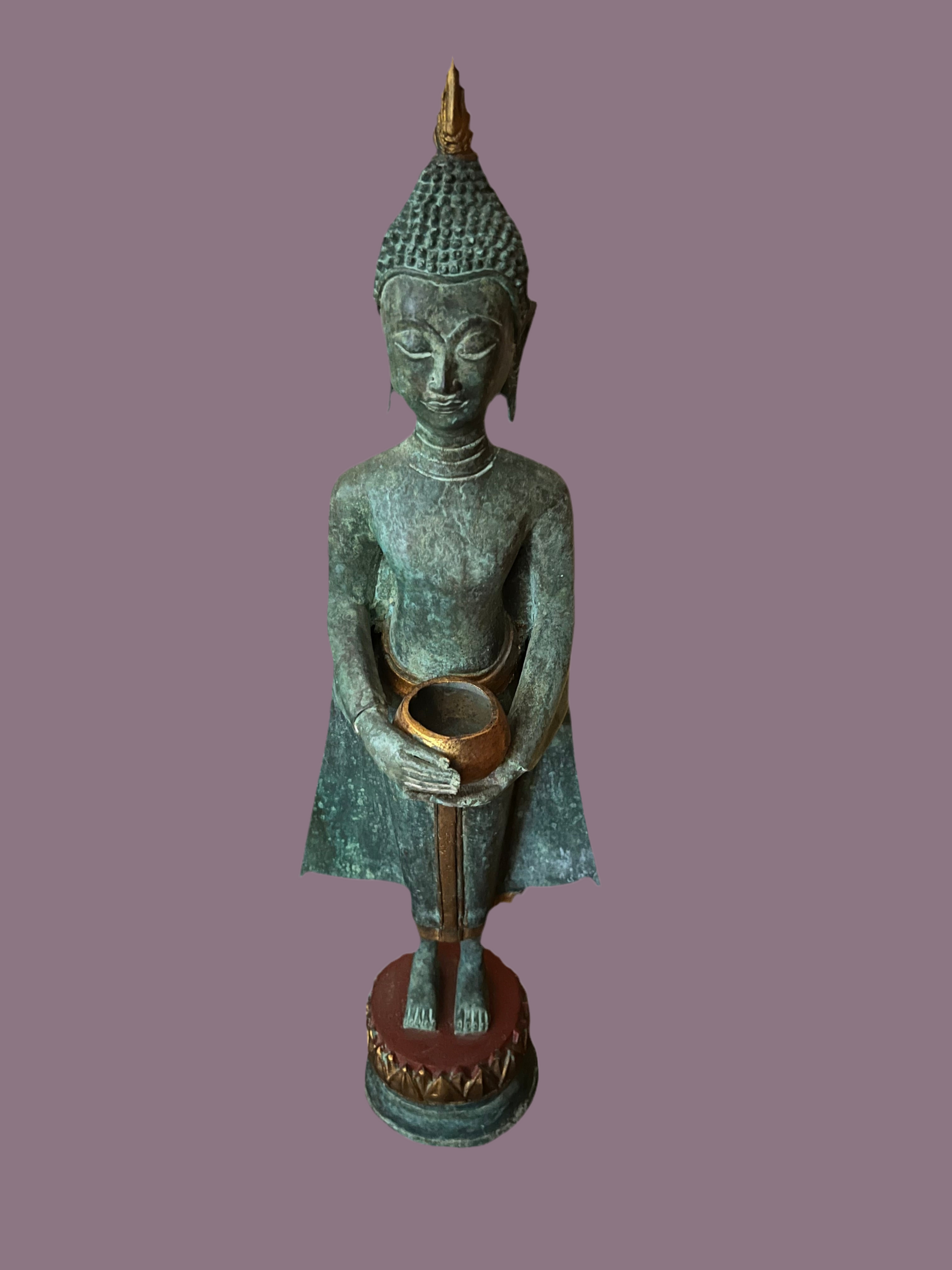A serene Buddha statue from the Saanskrityam Handicraft Store's Buddha Dharma collection elegantly holds a bowl in its lap. Featuring intricate hair curls, elongated ears, and a flame-like ornament atop its head, this piece enhances any Buddha collection. It stands gracefully on a round, decorated base.