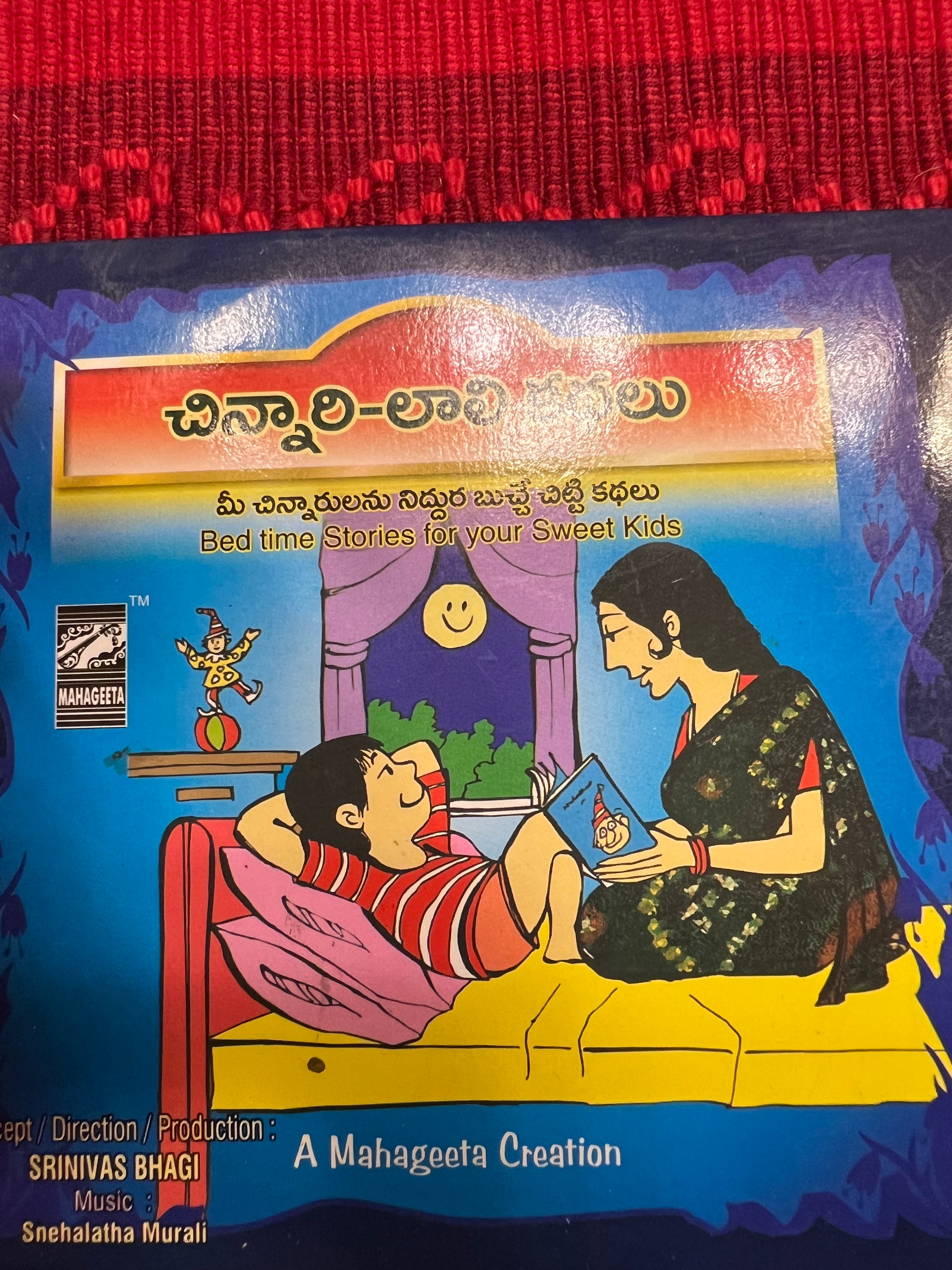 Three packages of the Indian Music Collection incense sticks from Saanskrityam Handicraft Store are arranged on a red fabric. The purple boxes with gold text, featuring an OM symbol and various logos, evoke rich fragrances akin to the soothing notes of Carnatic music.