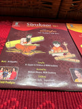 Three packages of the Indian Music Collection incense sticks from Saanskrityam Handicraft Store are arranged on a red fabric. The purple boxes with gold text, featuring an OM symbol and various logos, evoke rich fragrances akin to the soothing notes of Carnatic music.