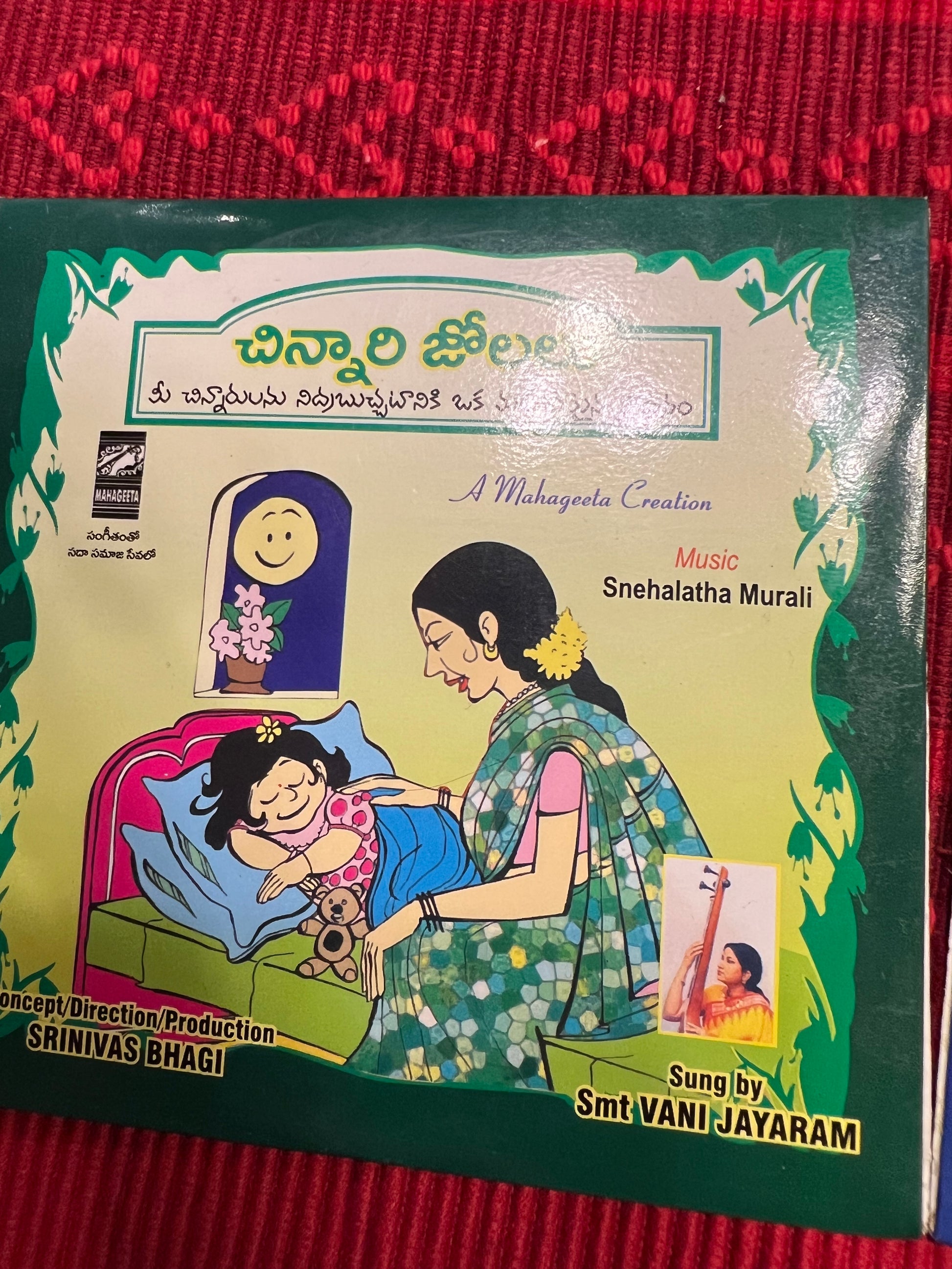 Three packages of the Indian Music Collection incense sticks from Saanskrityam Handicraft Store are arranged on a red fabric. The purple boxes with gold text, featuring an OM symbol and various logos, evoke rich fragrances akin to the soothing notes of Carnatic music.