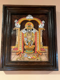 A framed piece of Karnataka rosewood art from the Saanskrityam Handicraft Store depicts a traditional royal procession. The scene includes a chariot with two seated figures, an elephant guided by attendants, and people on foot against a stylized backdrop. The ornate frame is intricately carved from rosewood.