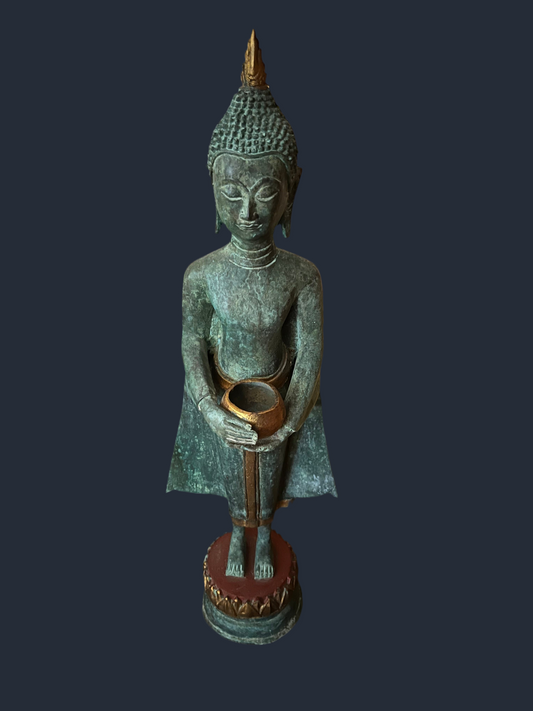 A serene Buddha statue from the Saanskrityam Handicraft Store's Buddha Dharma collection elegantly holds a bowl in its lap. Featuring intricate hair curls, elongated ears, and a flame-like ornament atop its head, this piece enhances any Buddha collection. It stands gracefully on a round, decorated base.