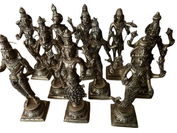 A collection of beautifully crafted Dasavataaram 12-inch bronze figurines from Saanskrityam Handicraft Store, featuring ten deities in unique poses and adorned with elaborate ornaments, each standing on a square base. The figures are displayed together, highlighting exceptional attention to detail and artistry.