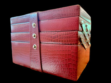 Red textured jewelry box on a patterned surface