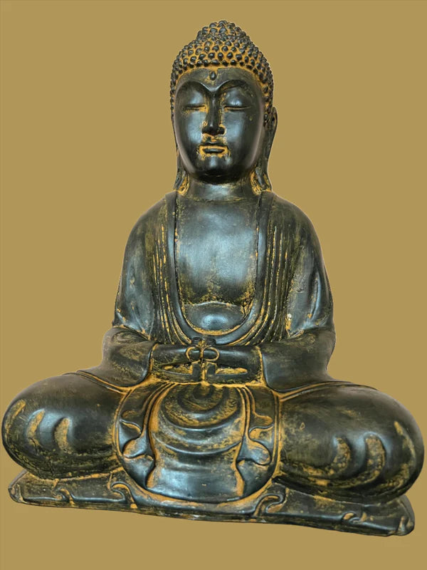 An Indonesian volcanic stone Buddha from Saanskrityam Handicraft Store, showcasing a meditative pose with intricate detailing against a plain background. The Buddha's eyes are closed, and its hands rest in a specific mudra that symbolizes peace and calmness.