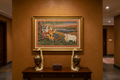 Radha Krishna on Swing Hindola Pichwai painting displayed above console in an elegant Indian hallway