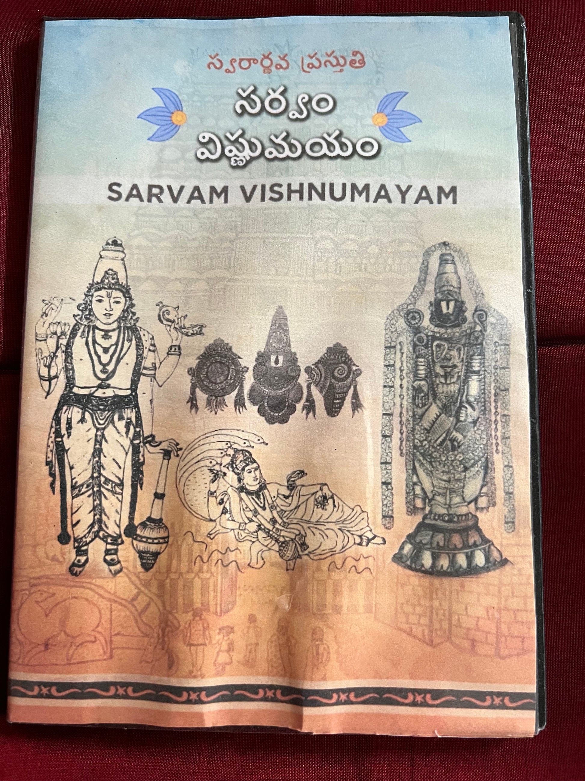 Three packages of the Indian Music Collection incense sticks from Saanskrityam Handicraft Store are arranged on a red fabric. The purple boxes with gold text, featuring an OM symbol and various logos, evoke rich fragrances akin to the soothing notes of Carnatic music.